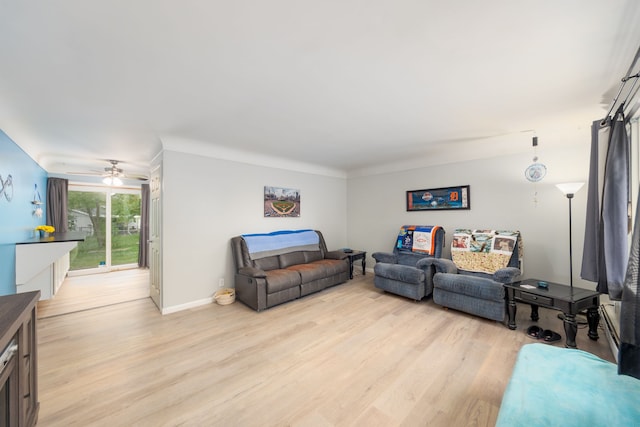 living area with light wood-style flooring, baseboards, and a ceiling fan