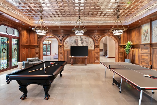 playroom with arched walkways, plenty of natural light, a tray ceiling, and billiards