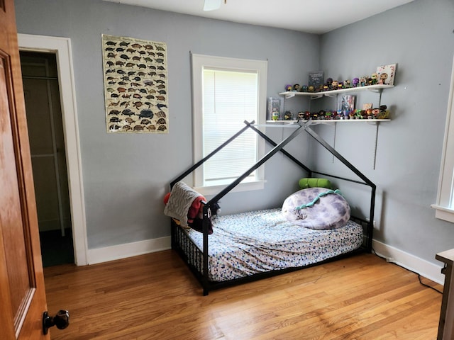 bedroom with wood finished floors and baseboards