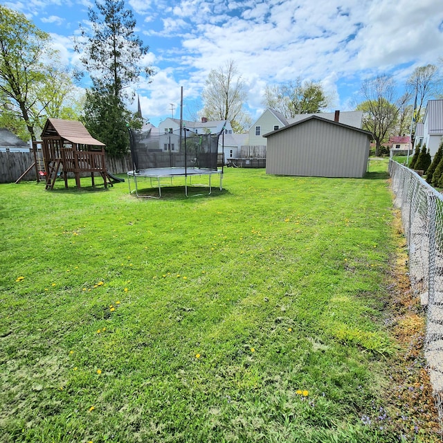 view of yard featuring a fenced backyard, a trampoline, and a playground