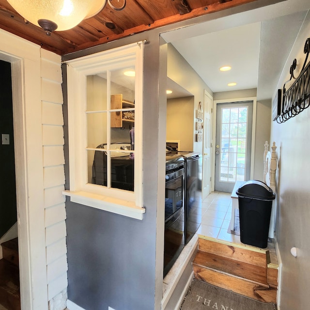 interior space featuring washing machine and dryer, tile patterned flooring, and recessed lighting