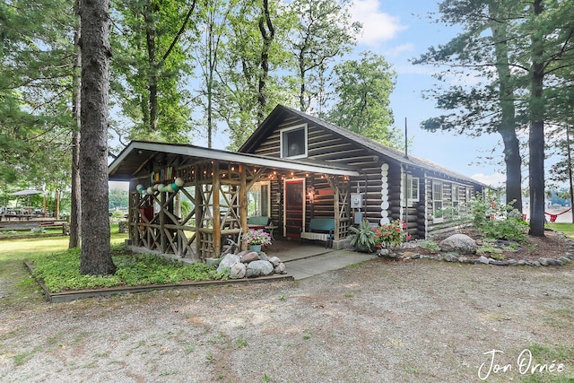 back of property featuring log exterior
