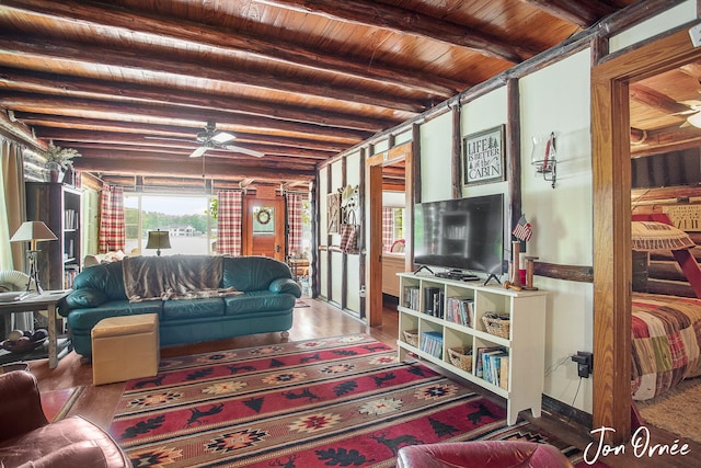 living area with wooden ceiling, beamed ceiling, a ceiling fan, and wood finished floors