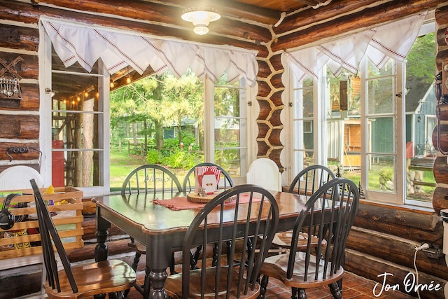 sunroom / solarium featuring french doors
