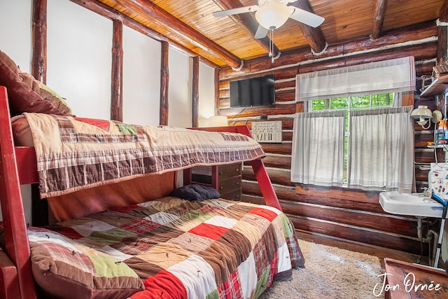 bedroom with wood finished floors, wood ceiling, rustic walls, and beam ceiling