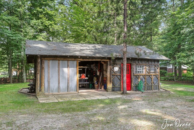 view of outbuilding featuring an outbuilding and fence