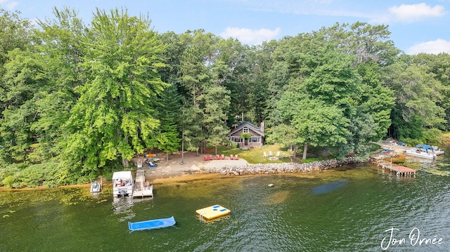 aerial view featuring a water view and a forest view