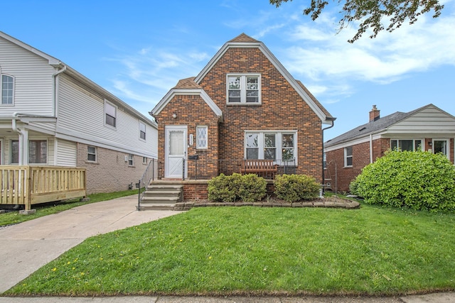 view of front of house with brick siding and a front yard