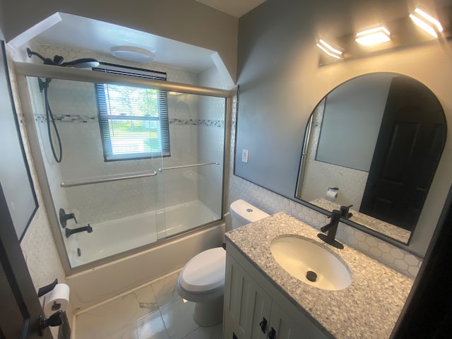 full bath featuring toilet, enclosed tub / shower combo, marble finish floor, and vanity