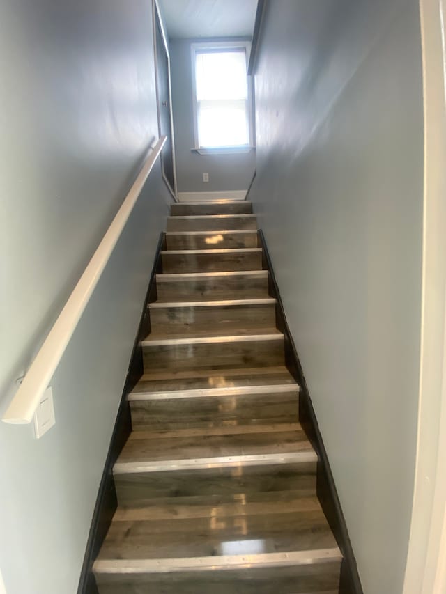 stairway with wood finished floors