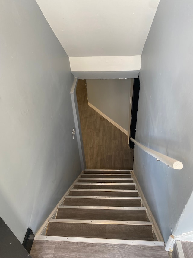 staircase with wood finished floors