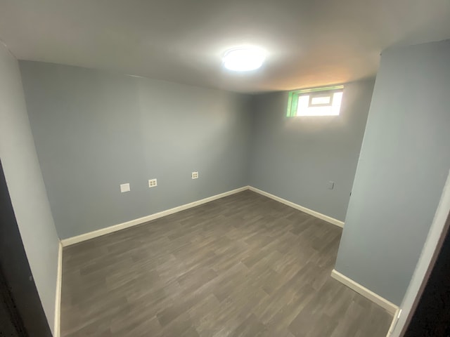 interior space with dark wood-type flooring and baseboards