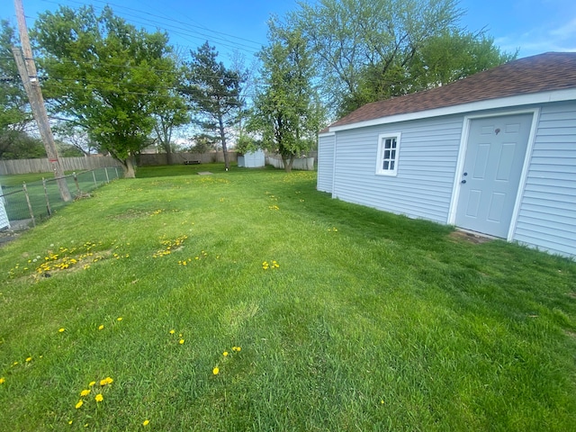 view of yard with an outdoor structure and a fenced backyard