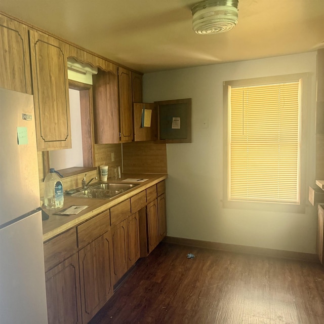 2905 W Burt Rd, Montrose, MI 48457 - kitchen with freestanding refrigerator, baseboards, dark wood-style flooring, a sink, and light countertops