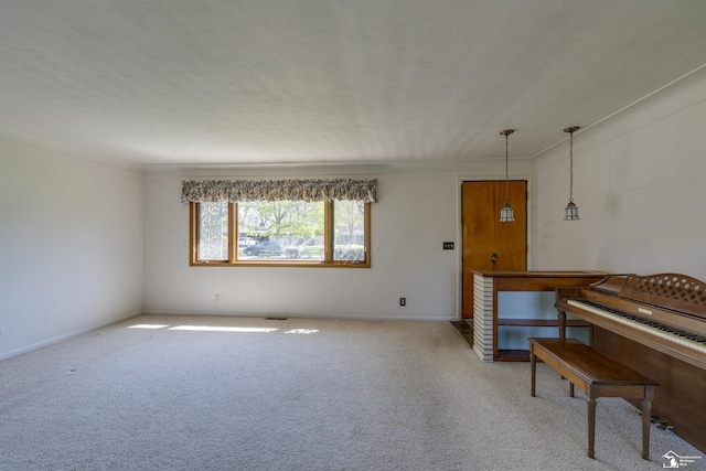 interior space with carpet flooring, baseboards, and visible vents