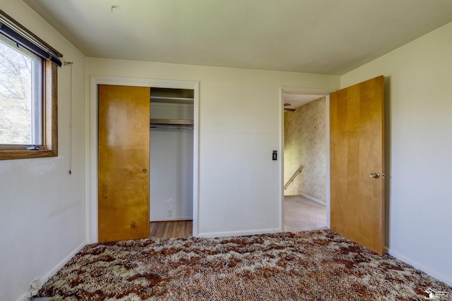 unfurnished bedroom featuring a closet and baseboards
