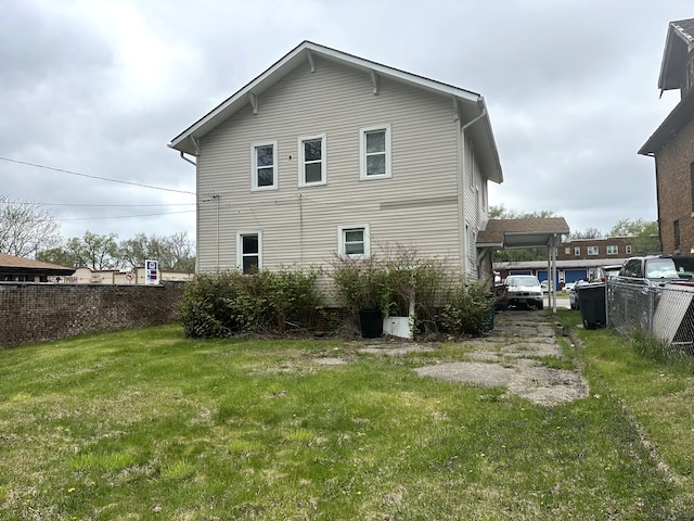 back of house featuring a yard and fence