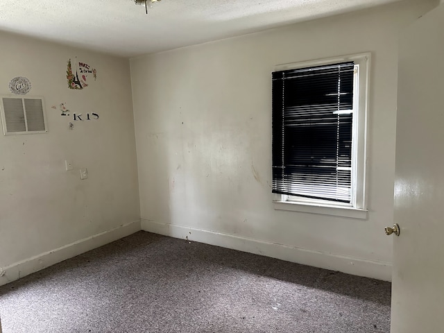 unfurnished room with carpet flooring, baseboards, and visible vents