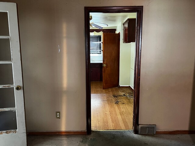 hall featuring baseboards