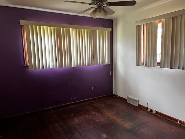 spare room with a ceiling fan, wood finished floors, and baseboards