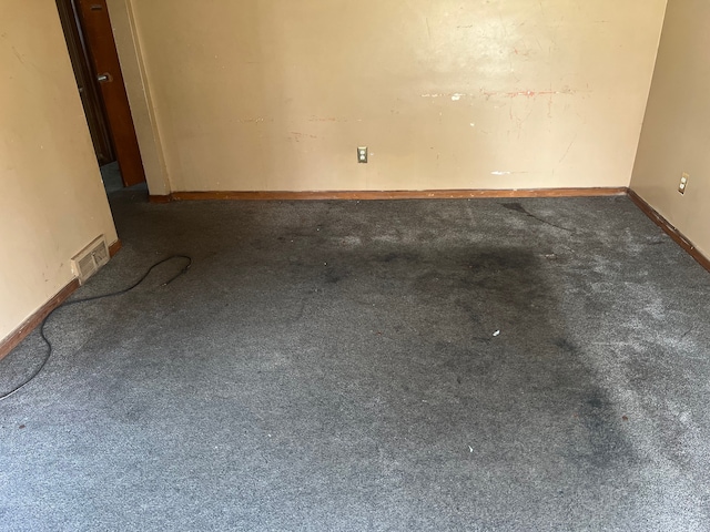 unfurnished room with carpet and baseboards