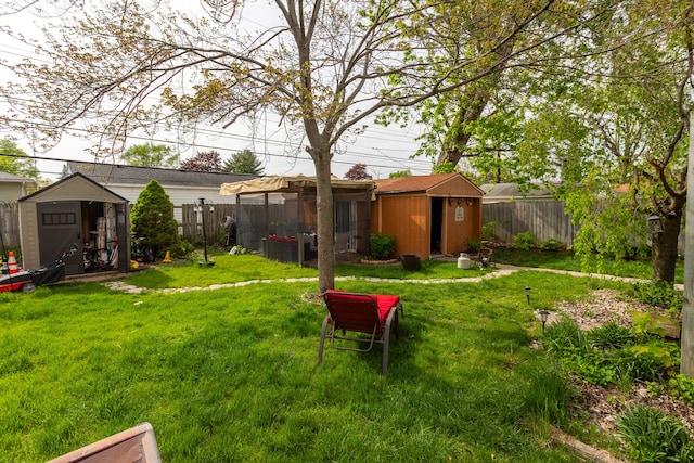 view of yard with a storage unit and an outbuilding