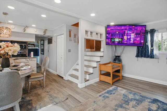 living room with baseboards, wood finished floors, stairway, crown molding, and recessed lighting