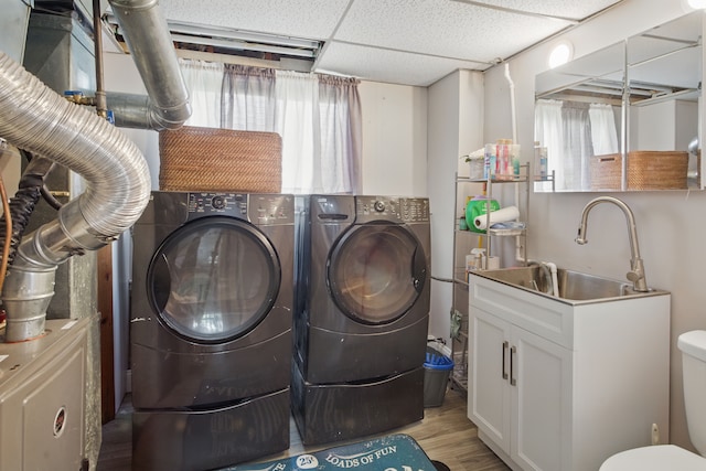 laundry area featuring washing machine and dryer and light wood-style floors