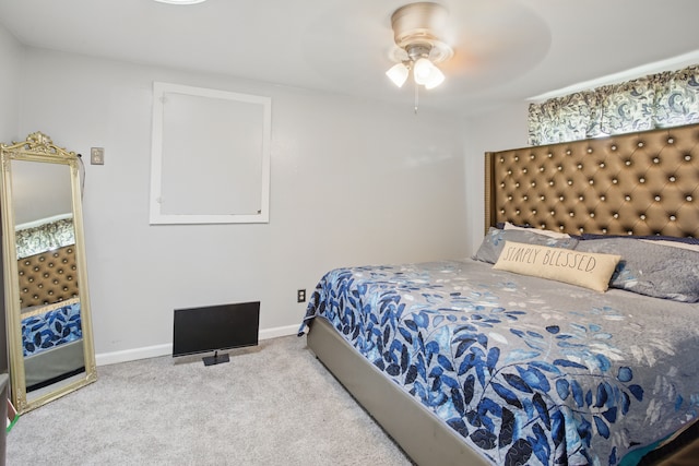 carpeted bedroom featuring baseboards and ceiling fan