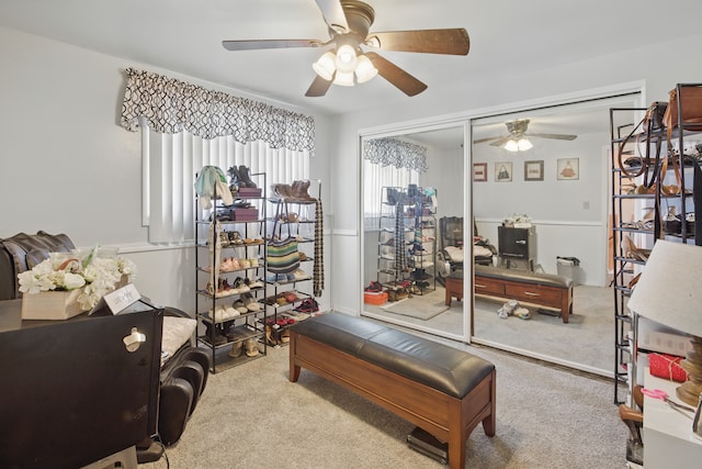exercise room with ceiling fan and carpet