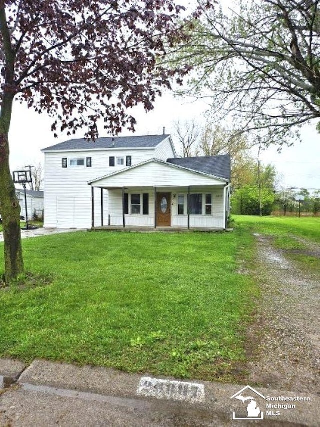 traditional home with a porch and a front yard