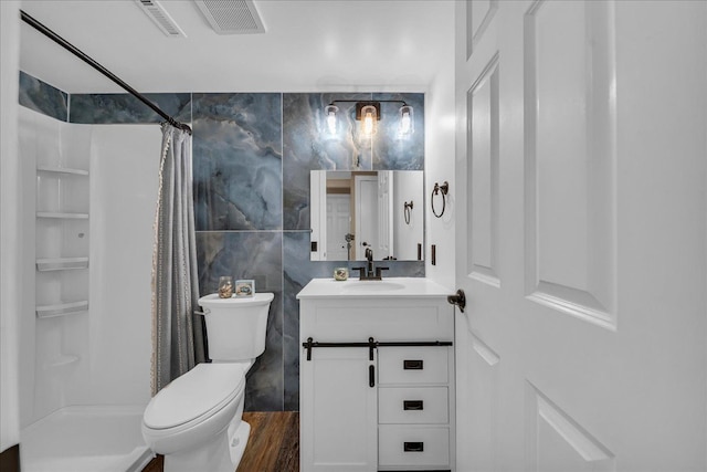 bathroom with vanity, toilet, a shower with curtain, and visible vents