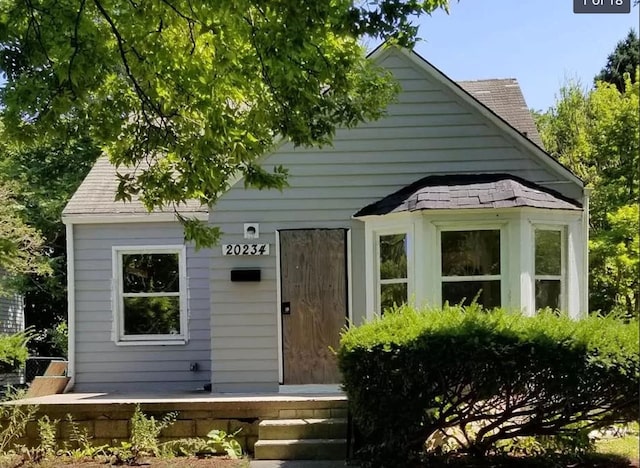exterior space featuring roof with shingles