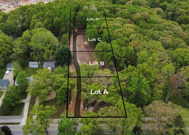 2395 Dunnigan Ave NE Unit C, Grand Rapids, MI 49525 - aerial view of property and surrounding area featuring a forest and property parcel outlined