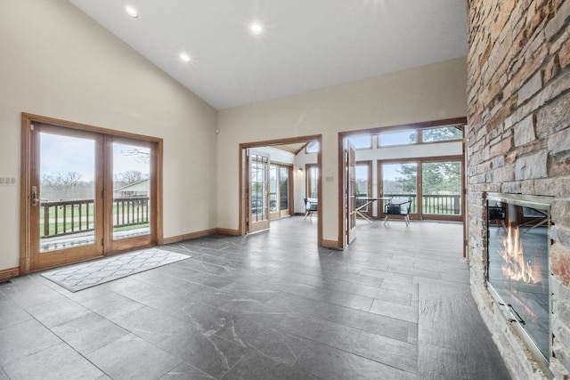 3101 Delano Rd, Oxford, MI 48371 - unfurnished living room featuring high vaulted ceiling, plenty of natural light, recessed lighting, a fireplace, and baseboards