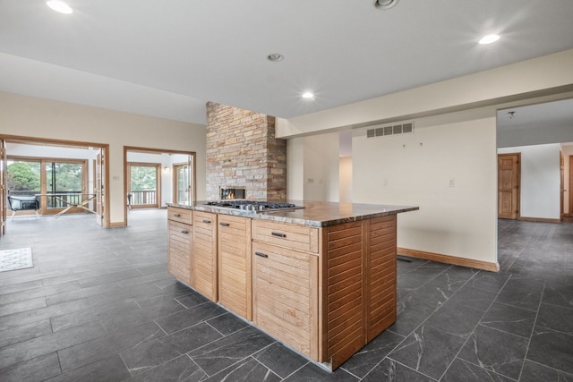 3101 Delano Rd, Oxford, MI 48371 - kitchen with stainless steel gas stovetop, a kitchen island, baseboards, recessed lighting, and light brown cabinetry