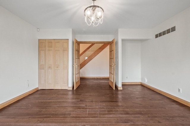 3101 Delano Rd, Oxford, MI 48371 - unfurnished bedroom with dark wood-style floors, a chandelier, baseboards, and a closet