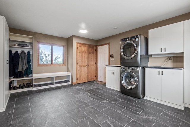 3101 Delano Rd, Oxford, MI 48371 - washroom featuring cabinet space, stacked washer and clothes dryer, baseboards, and recessed lighting