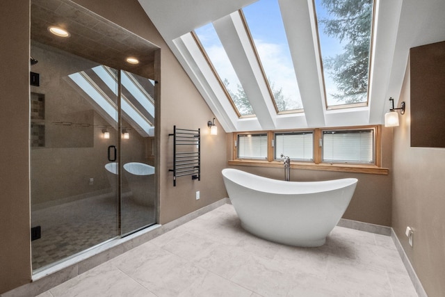 3101 Delano Rd, Oxford, MI 48371 - bathroom with a skylight, baseboards, a shower stall, a freestanding tub, and vaulted ceiling