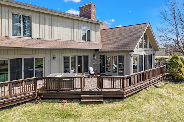 3101 Delano Rd, Oxford, MI 48371 - back of house with a chimney, a yard, a sunroom, a wooden deck, and roof with shingles