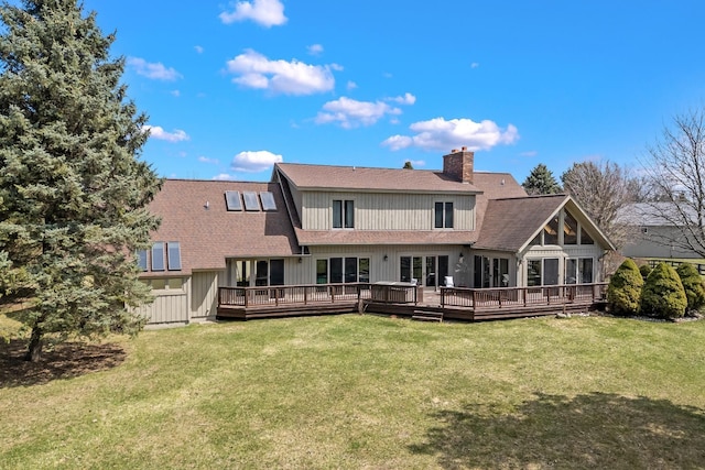 3101 Delano Rd, Oxford, MI 48371 - back of house featuring a shingled roof, a wooden deck, a chimney, and a lawn