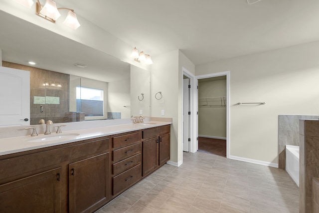 43547 Bolingbrooke Ln, Novi, MI 48377 - bathroom featuring a spacious closet, a garden tub, double vanity, baseboards, and tiled shower