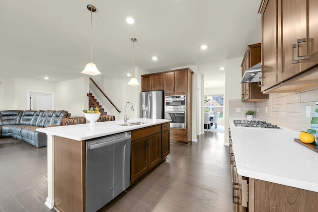43547 Bolingbrooke Ln, Novi, MI 48377 - kitchen with stainless steel appliances, a sink, open floor plan, tasteful backsplash, and dark wood finished floors