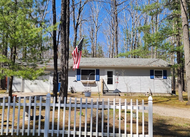 5608 Clifford St, Topinabee, MI 49791 - ranch-style home featuring a fenced front yard