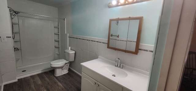 5608 Clifford St, Topinabee, MI 49791 - full bath with wood finished floors, a shower, toilet, tile walls, and vanity
