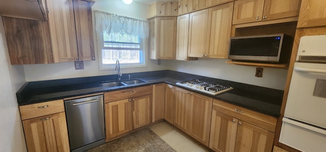 5608 Clifford St, Topinabee, MI 49791 - kitchen featuring a sink, appliances with stainless steel finishes, a warming drawer, and dark countertops
