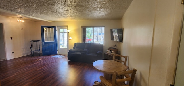 5608 Clifford St, Topinabee, MI 49791 - living area featuring wood finished floors, a textured ceiling, and baseboards
