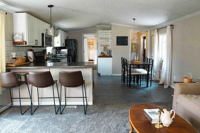 11005 Elm Ave, Howard City, MI 49329 - kitchen with freestanding refrigerator, stainless steel microwave, baseboards, decorative backsplash, and a peninsula