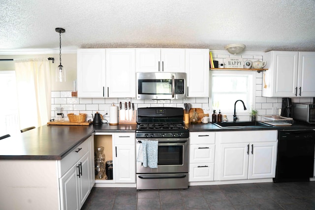 11005 Elm Ave, Howard City, MI 49329 - kitchen featuring appliances with stainless steel finishes, a sink, dark countertops, a textured ceiling, and white cabinets