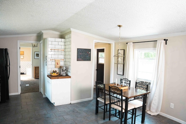 11005 Elm Ave, Howard City, MI 49329 - dining room with a textured ceiling, baseboards, and ornamental molding